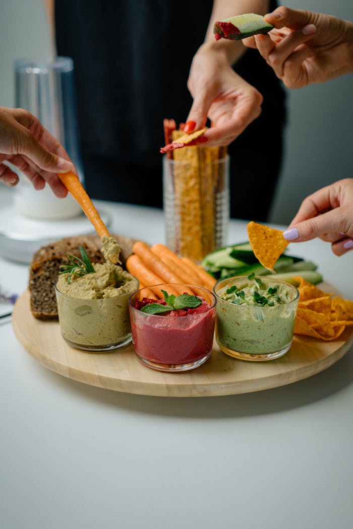 A colorful assortment of dips and vegetables perfect for a healthy snack.